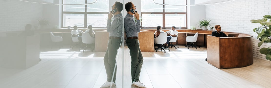 Business owner on phone in modern offiice, illustrating life insurance as a tool for business protection and continuity.